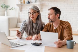 Middle-aged couple sitting at a computer